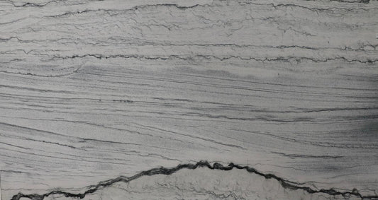 Large slab of gray marble with visible veins on display