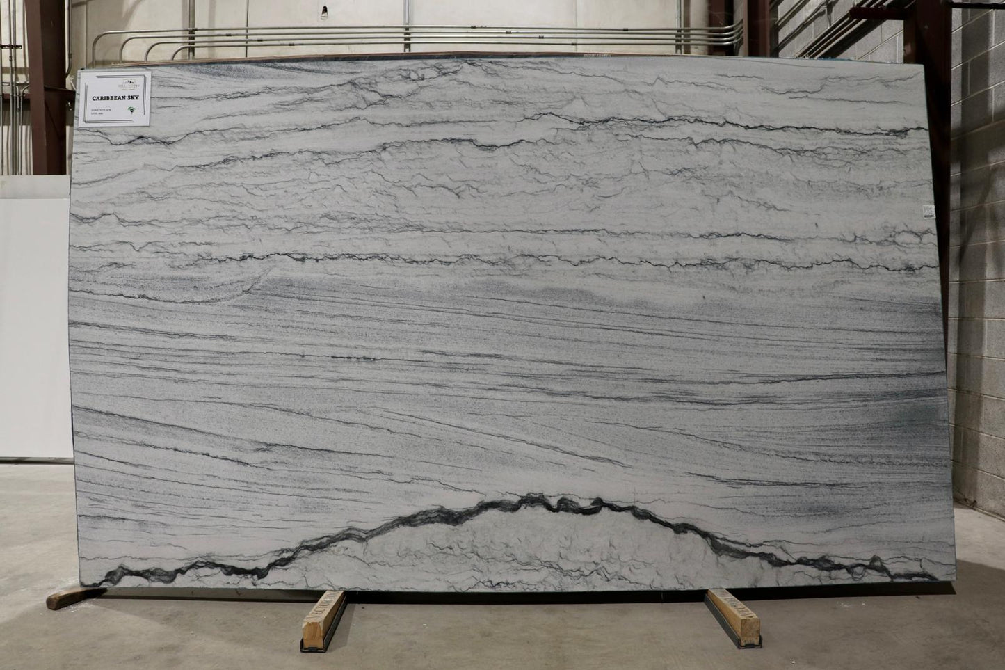 Large slab of gray marble with visible veins on display
