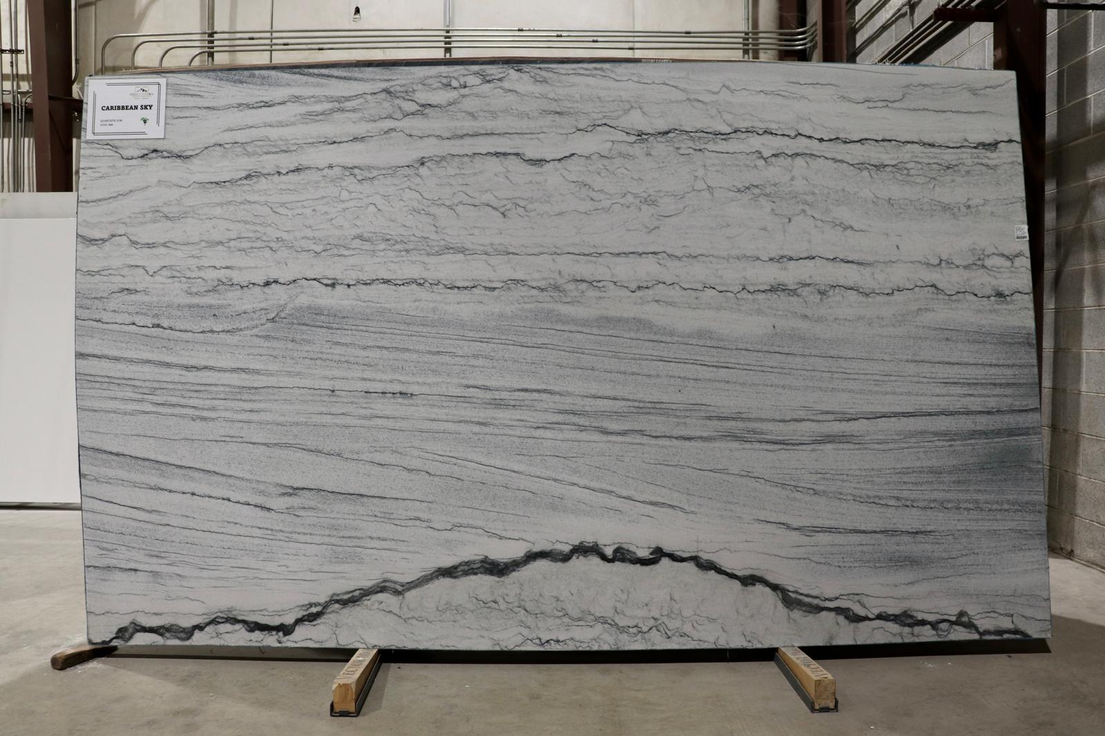 Large slab of gray marble with visible veins on display