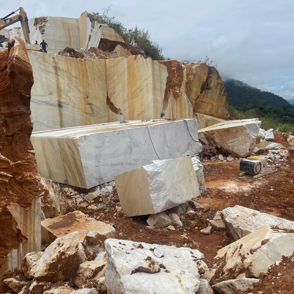 Marble blocks in a quarry with mountains in the background