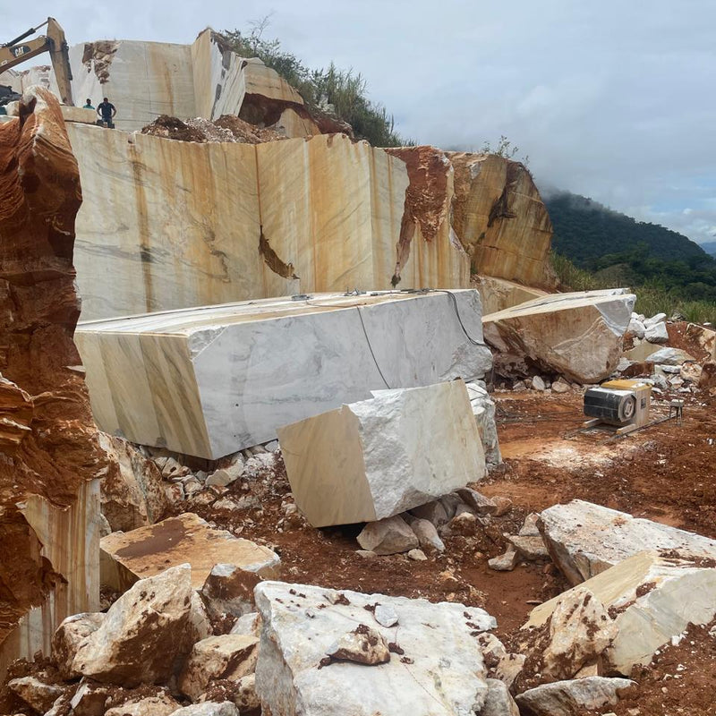 Marble blocks in a quarry with mountains in the background